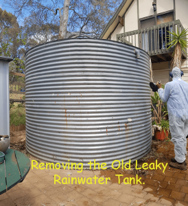 old leaky rainwater tank ready to be taken away