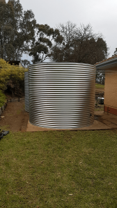 New rainwater tank next to old tank on existing concrete base