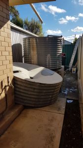 rainwater tank with old piece that has concrete lining